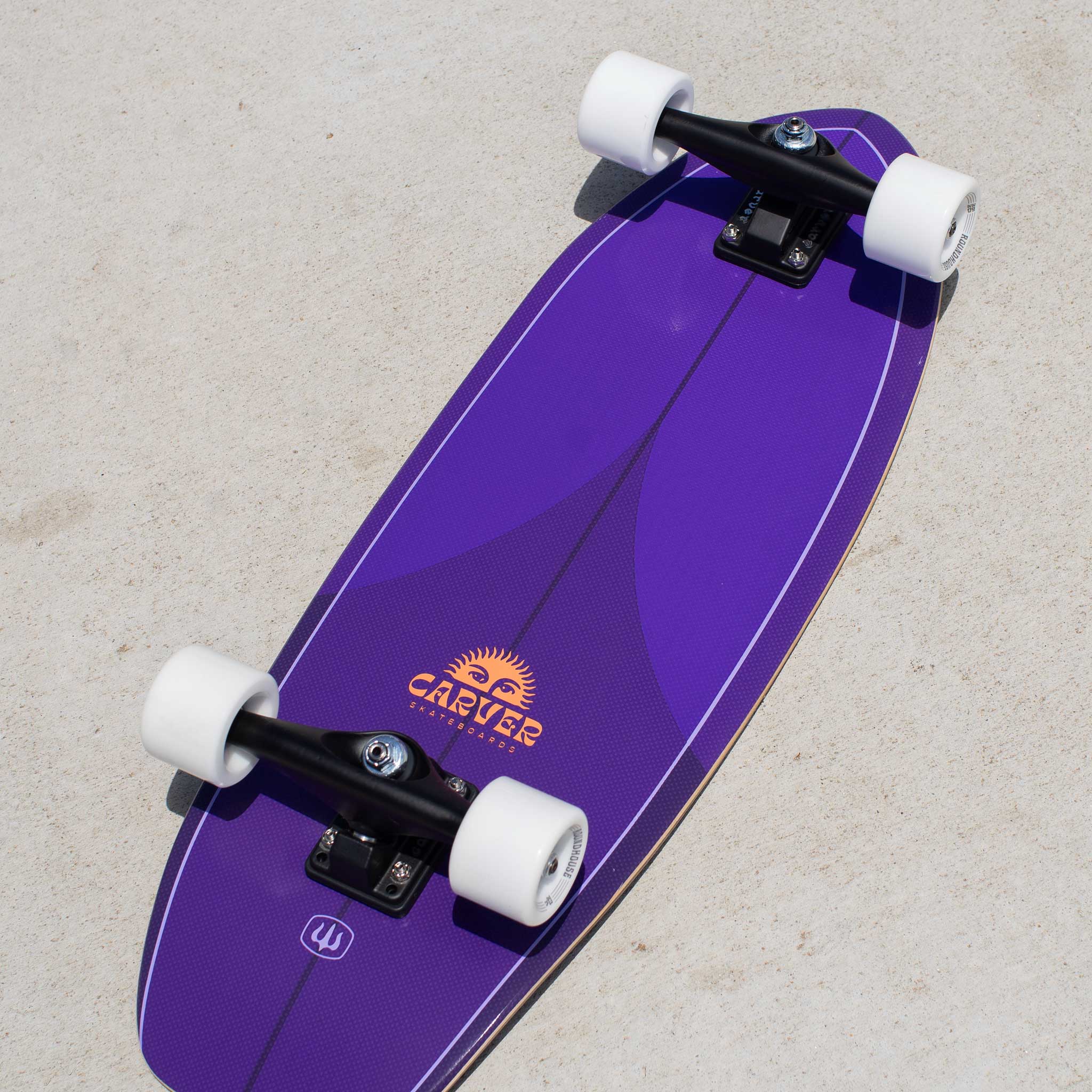 Purple Carver Purple Haze min surfskate skateboard with white wheels on a concrete surface