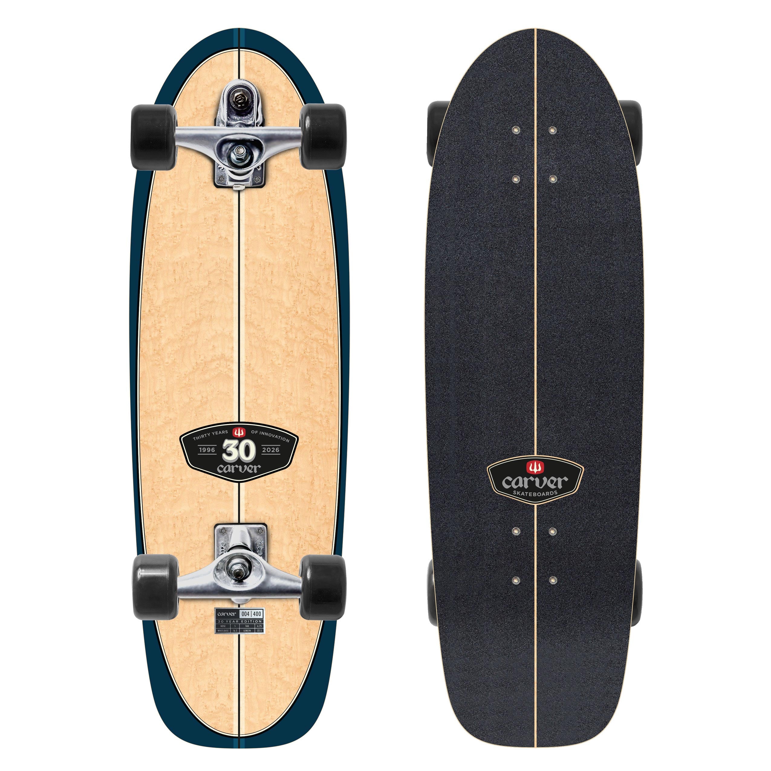 Top and bottom views of a Carver 30-Year Limited Edition surfskate skateboard on a white background. The bottom features a natural wood grain finish with a dark teal outline, while the top is covered in black grip tape with a center stripe cut out.