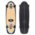 Top and bottom views of a Carver 30-Year Limited Edition surfskate skateboard on a white background. The bottom features a natural wood grain finish with a dark teal outline, while the top is covered in black grip tape with a center stripe cut out.