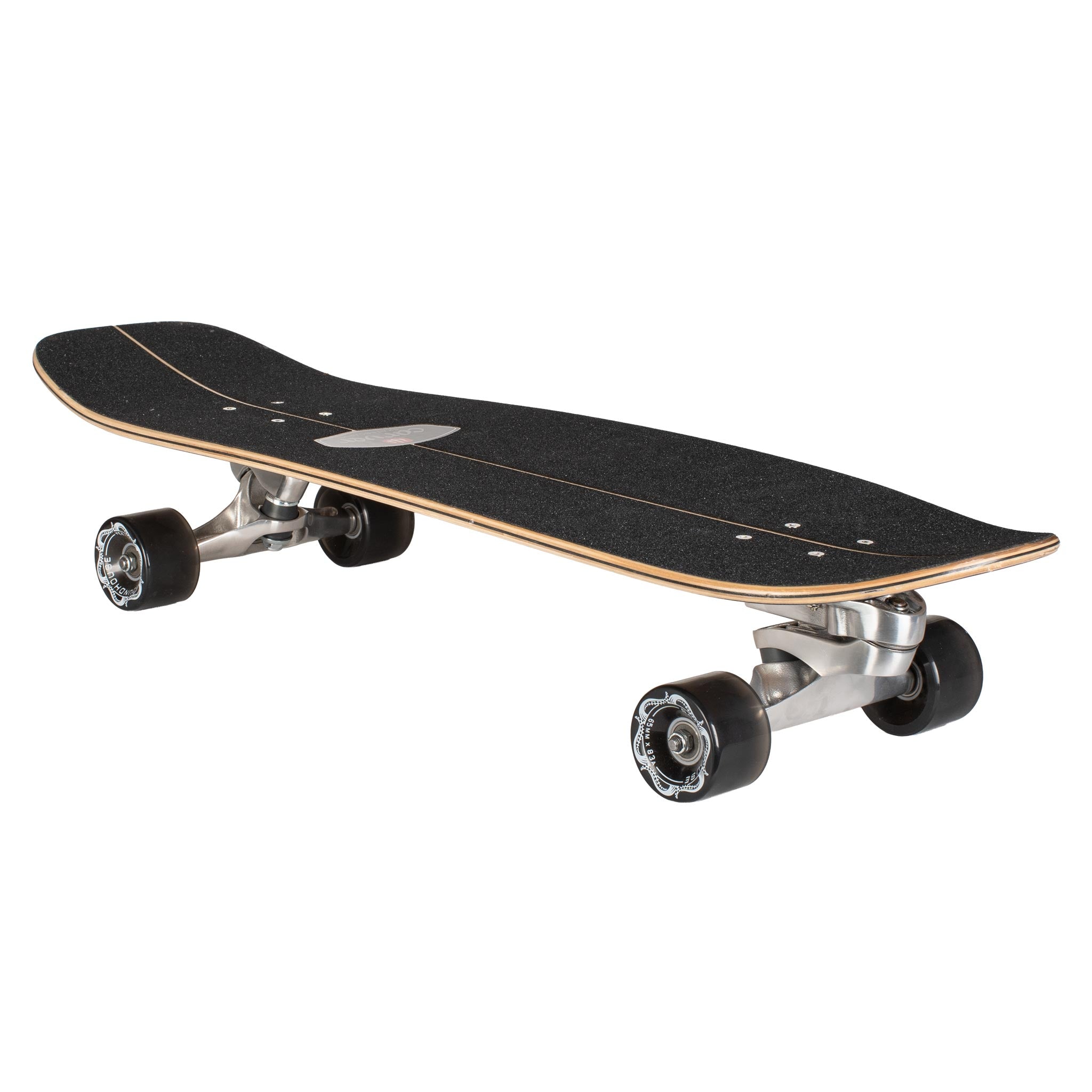 A Carver 30-Year Limited Edition surfskate skateboard with a black grip-tape deck, natural wood edge, silver metal trucks, and black wheels, shown from a three-quarters perspective on a white background.