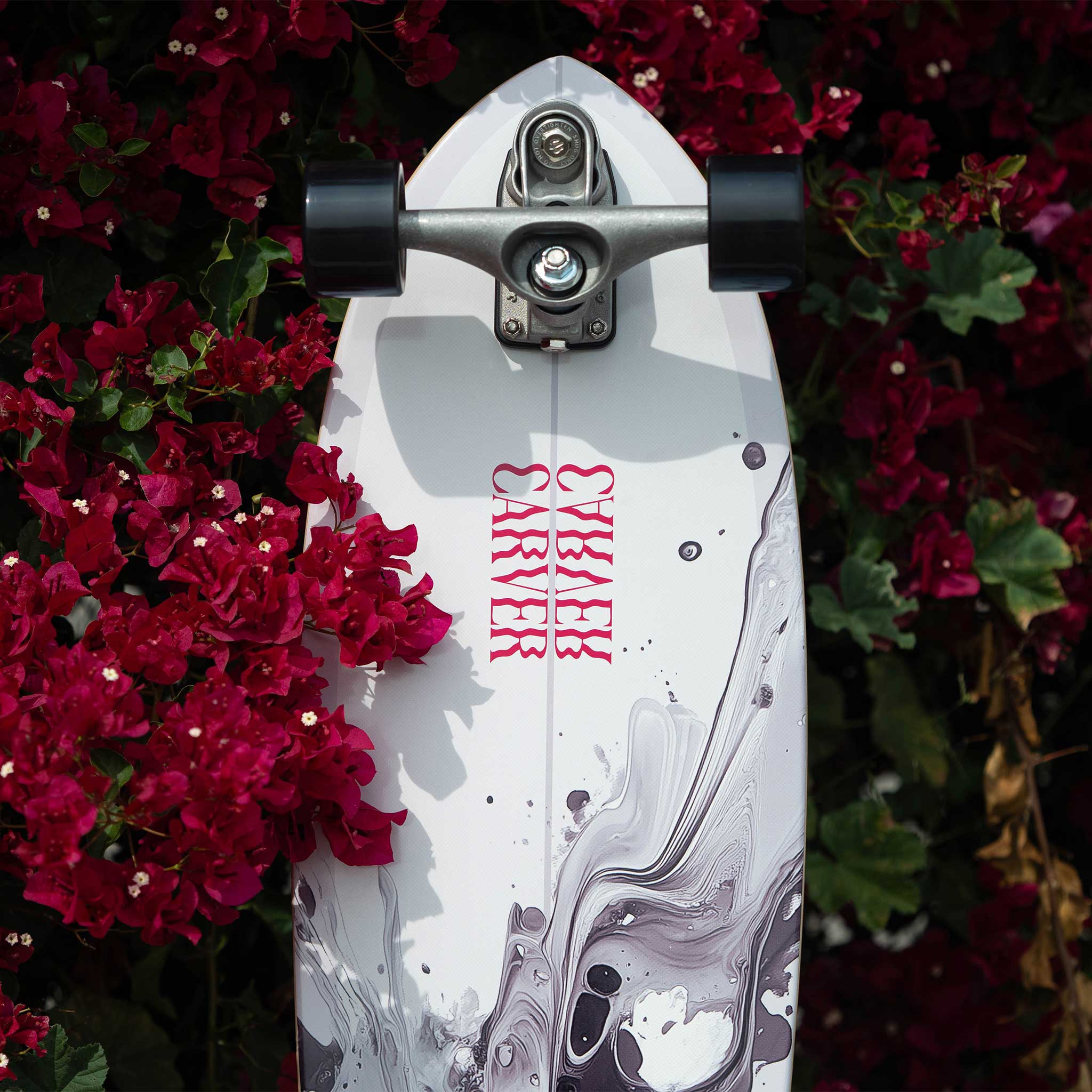 Carver 31" Resin | Surfskate Complete with red text on a floral background