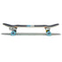 A skateboard viewed from the side, featuring a black grip tape surface and colorful wheels.