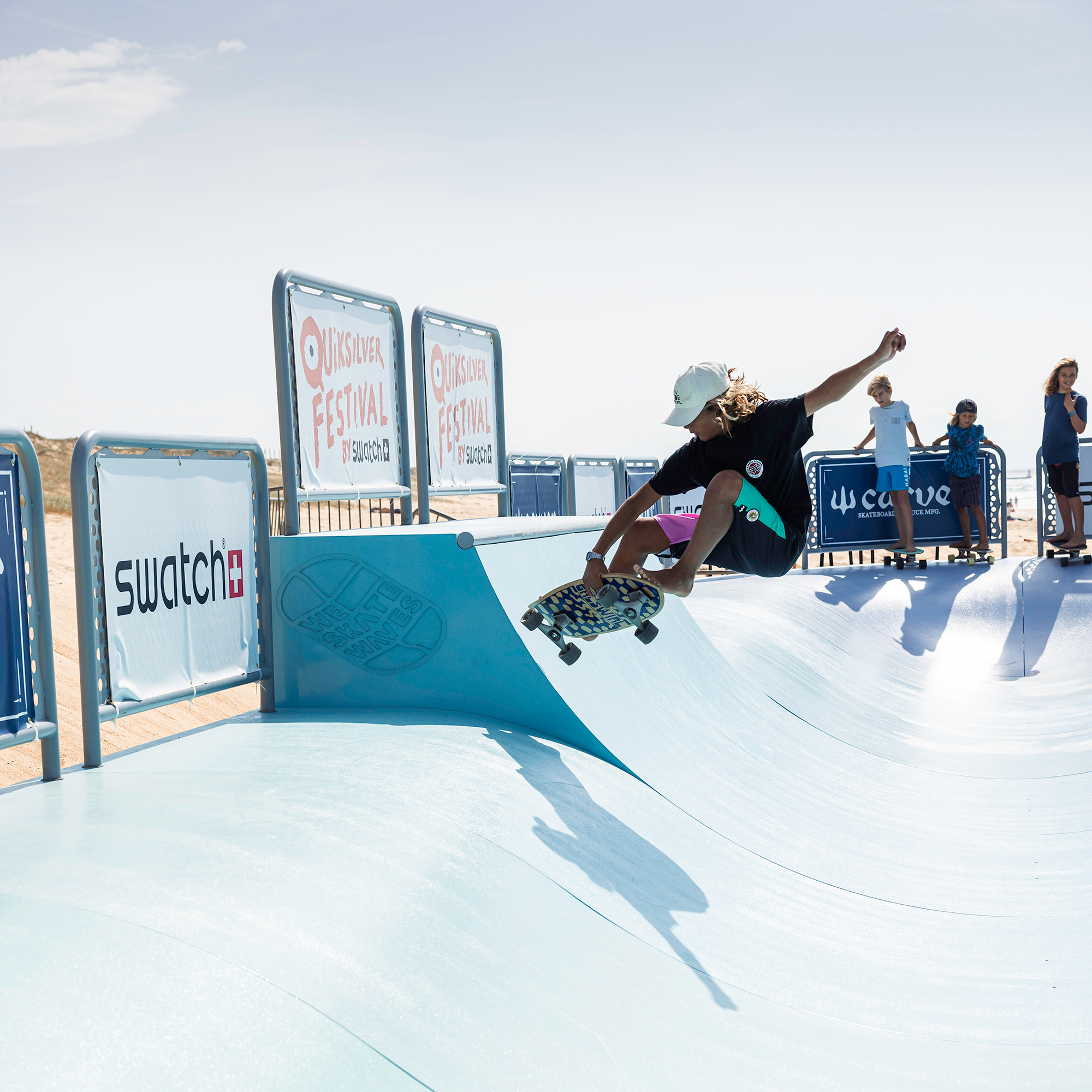 Surfskater hitting the lip of the Wavebank's steep wall